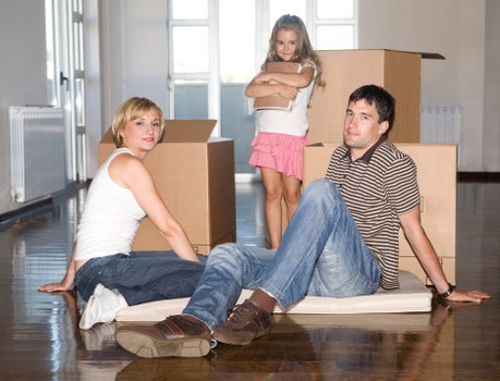 Careful loading of household items by a man with van removal team