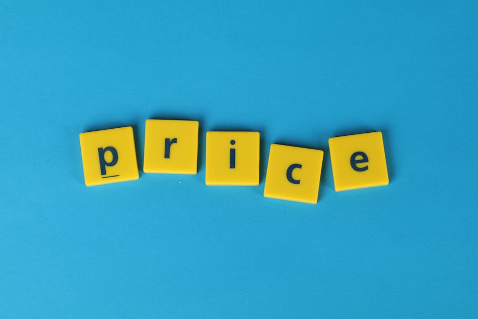 A close-up image showing the word 'price' spelled out with five yellow plastic letter blocks on a bright blue background. The blocks are arranged horizontally with slight tilts, and each has a lowercase letter printed in black. The setting is simple and clean, with no additional objects visible, conveying a focus on the concept of pricing, relevant to home relocation and moving services offered by Man With a Van Beddington. The image emphasizes clarity and straightforwardness, suitable for illustrating topics related to transparent pricing in house removals or moving logistics.